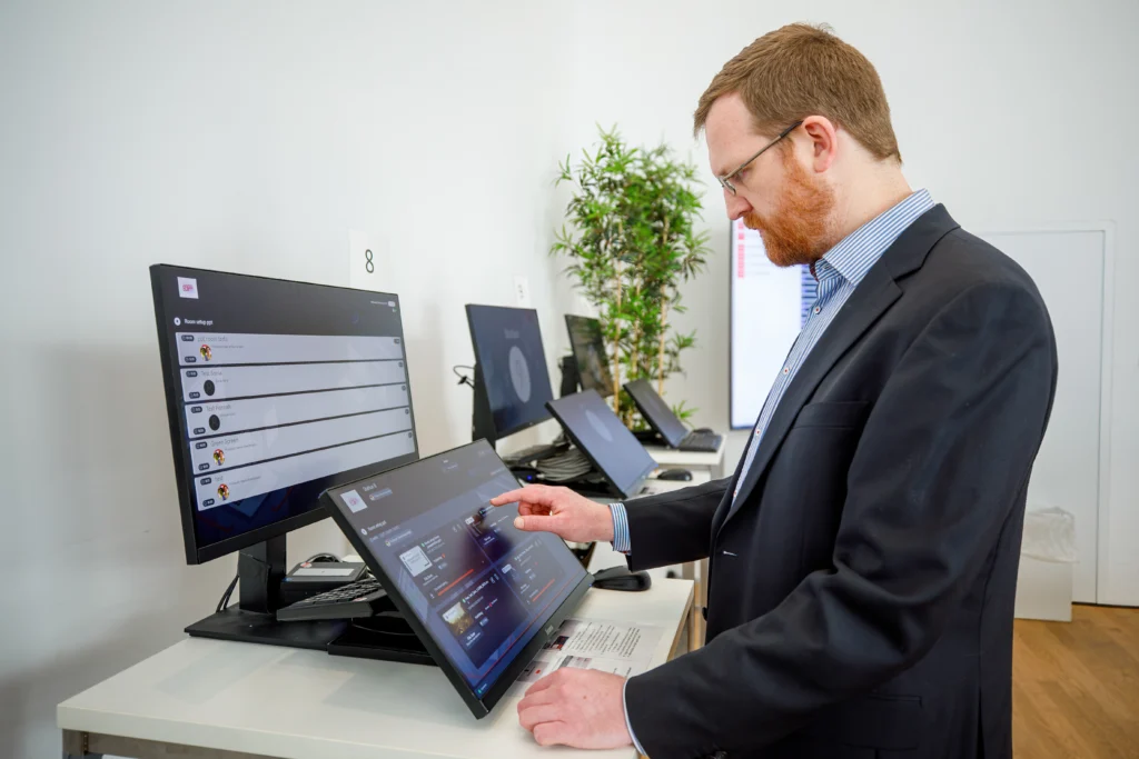 Presenter using a touchscreen with the Slidecrew software at a self-check station in the Speaker Ready Room