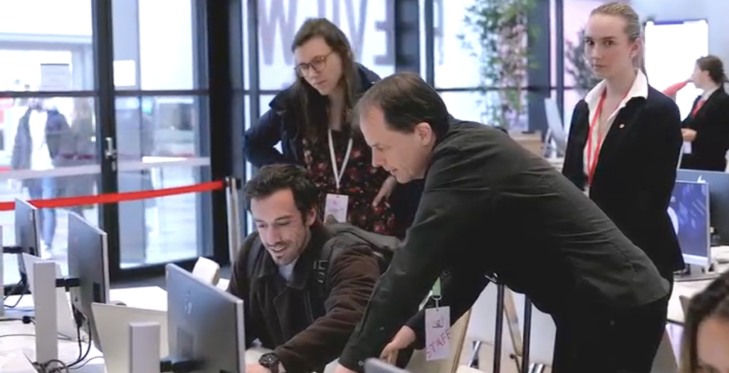 Technical support staff assisting a presenter with correcting their slides in the Speaker Ready Room