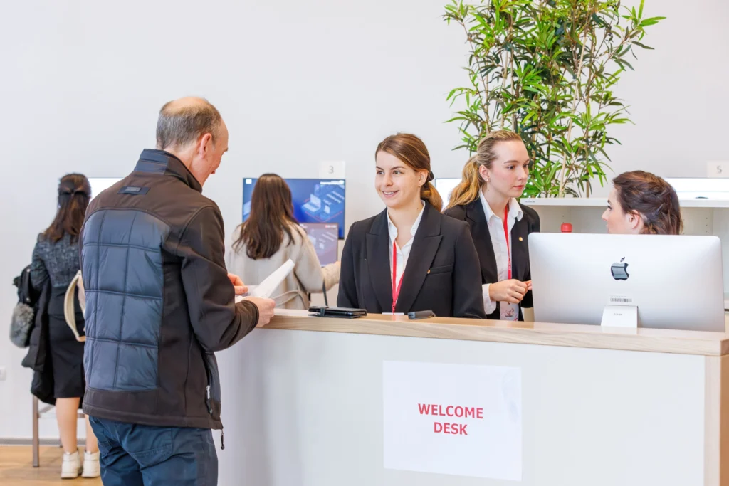 Speaker checking in at the welcome desk at the Speakers checking their files in the Speaker Ready Room