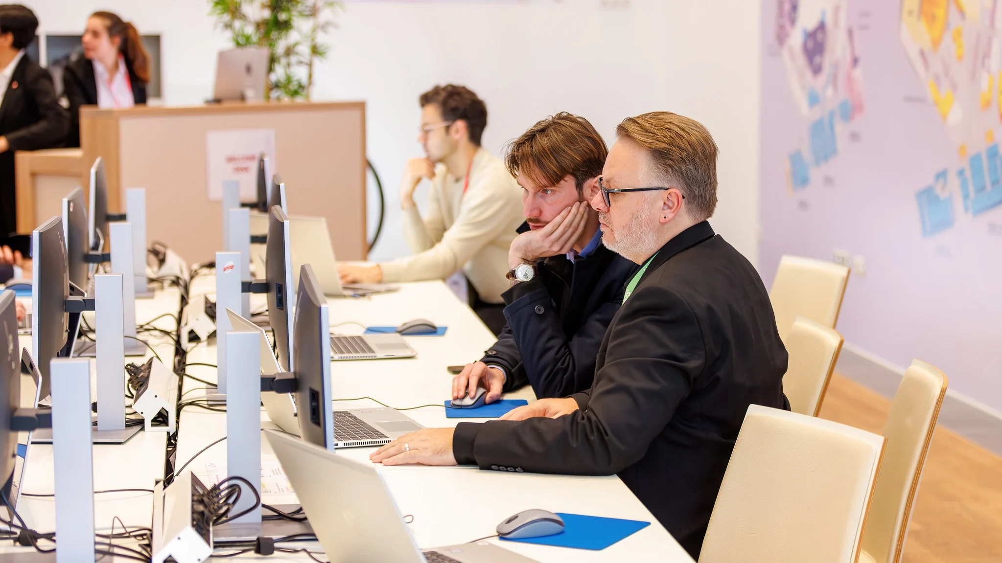 Technical staff assisting a presenter with their powerpoint slides in the Speaker Ready Room