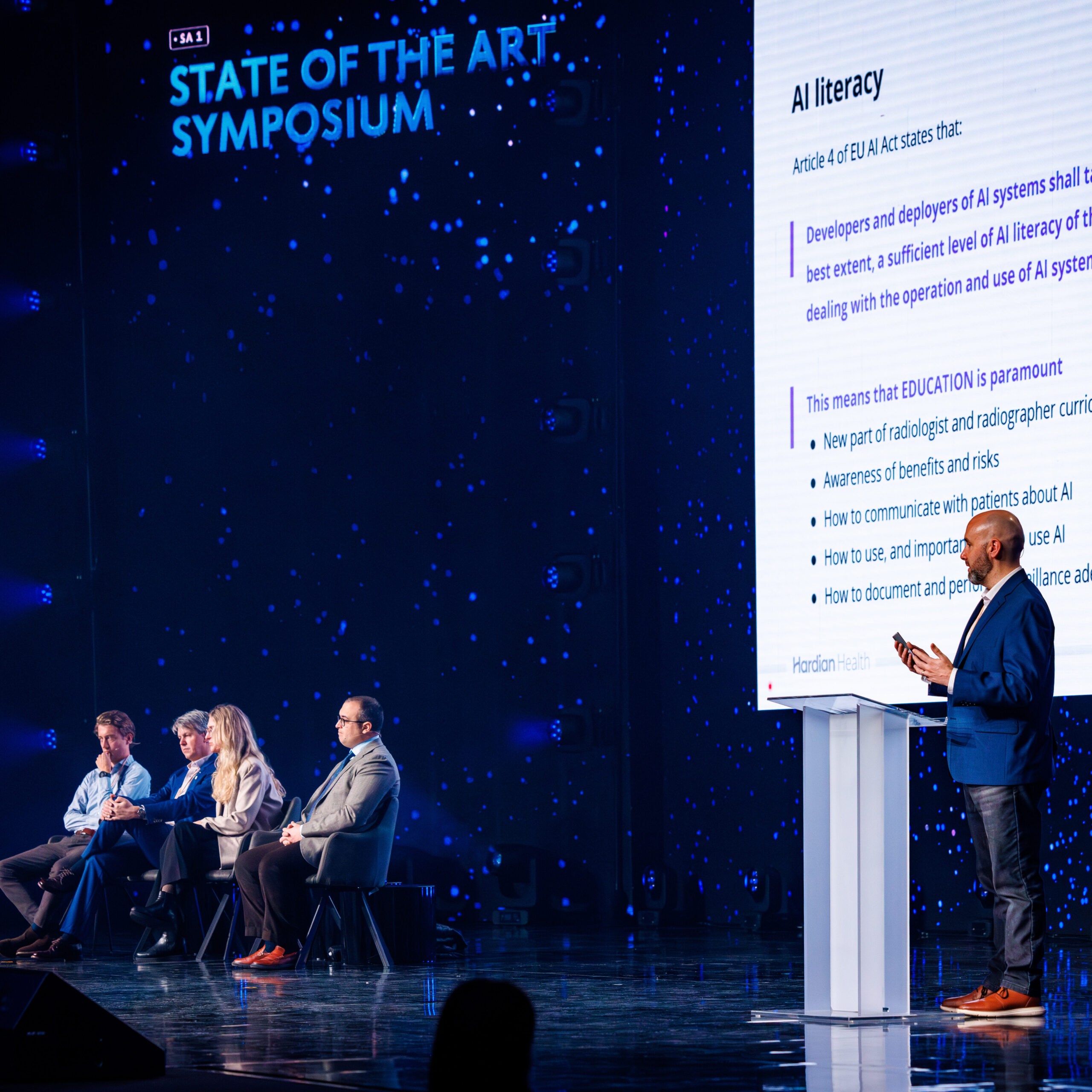Presenter holding a presentation on a very large LED screen