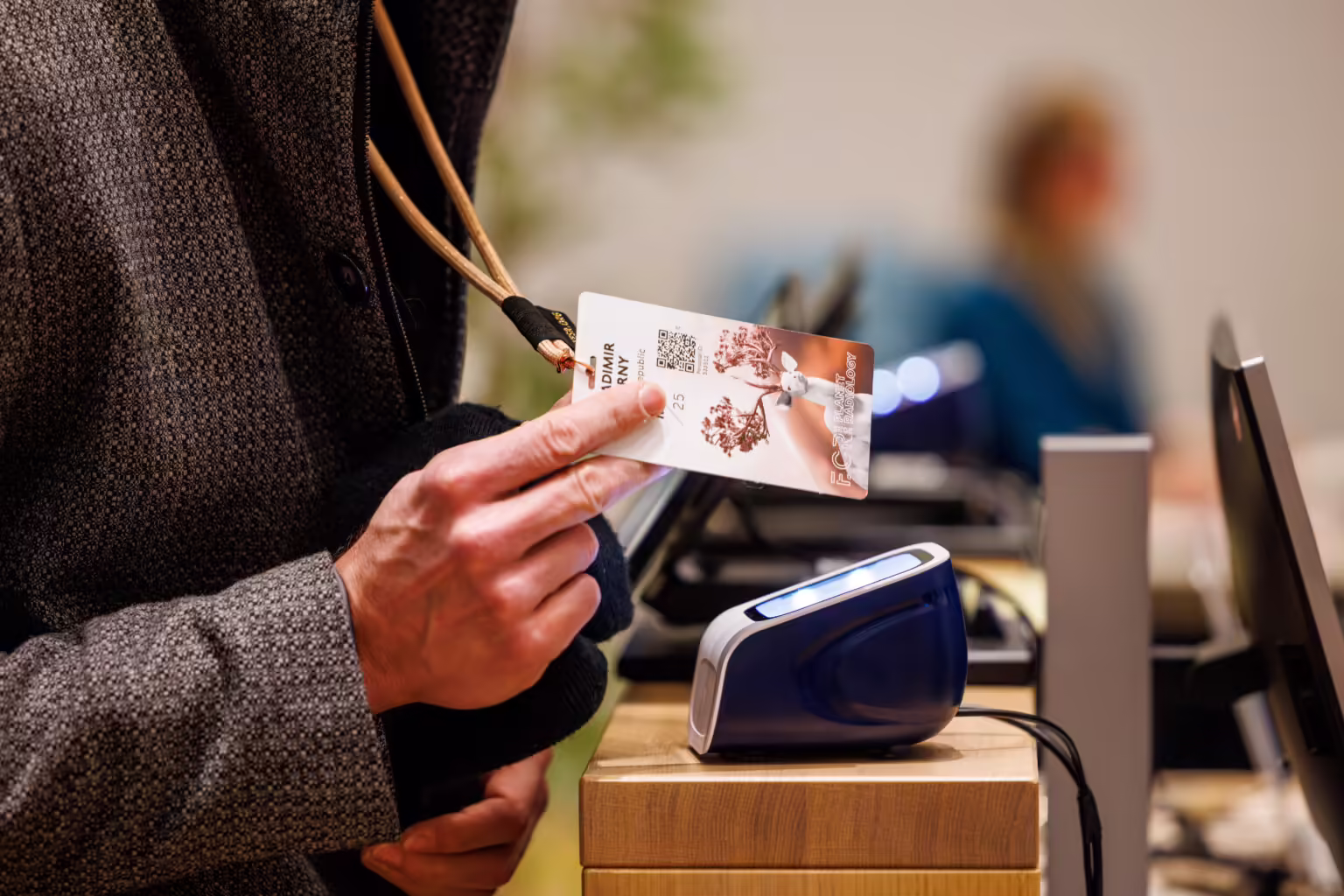 Conference speaker scanning their badge at the Slidecrew welcome desk to check in and access their presentation files quickly and securely.